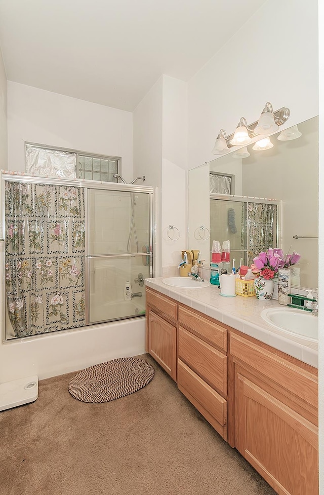 4223 W Yale Ave, Fresno, CA 93722 - full bathroom featuring double vanity, combined bath / shower with glass door, and carpet floors