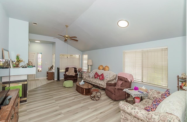 4223 W Yale Ave, Fresno, CA 93722 - living room featuring vaulted ceiling, a ceiling fan, healthy amount of natural light, wood finished floors, and baseboards