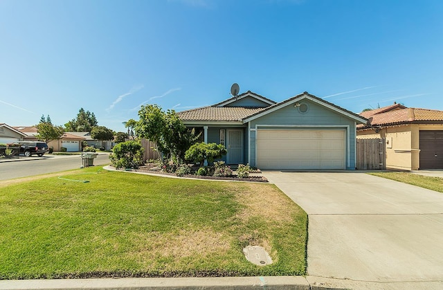 4223 W Yale Ave, Fresno, CA 93722 - ranch-style house featuring an attached garage, a tiled roof, and concrete driveway