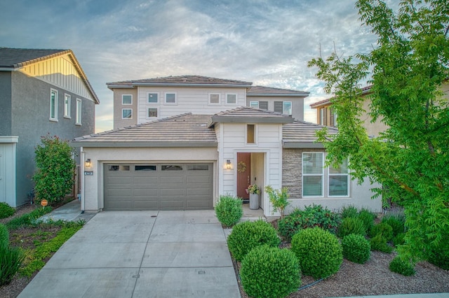 4284 Hillside Rd, Madera, CA 93636 - view of front facade with concrete driveway, an attached garage, stucco siding, and a tile roof