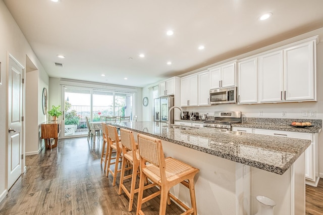 4284 Hillside Rd, Madera, CA 93636 - kitchen with appliances with stainless steel finishes, a sink, wood finished floors, recessed lighting, and white cabinetry