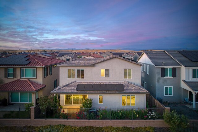 4284 Hillside Rd, Madera, CA 93636 - view of front facade featuring stucco siding, solar panels, and a fenced backyard
