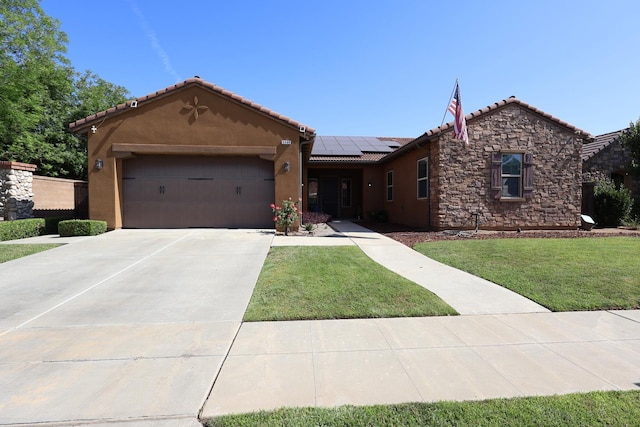 3309 Beverly Ave, Clovis, CA 93619 - ranch-style house with an attached garage, a tile roof, roof mounted solar panels, stucco siding, and a front lawn