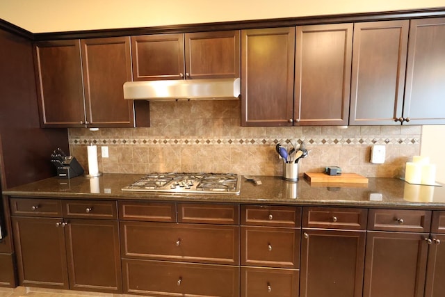 3309 Beverly Ave, Clovis, CA 93619 - kitchen with stainless steel gas cooktop, under cabinet range hood, backsplash, and dark stone countertops