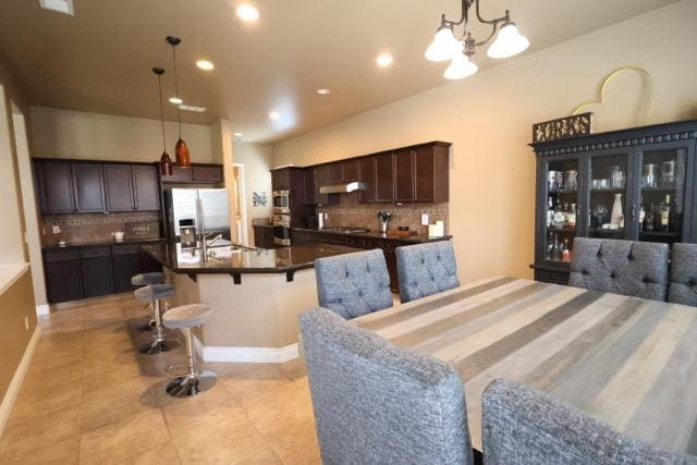 3309 Beverly Ave, Clovis, CA 93619 - dining area with light tile patterned floors, recessed lighting, and a chandelier