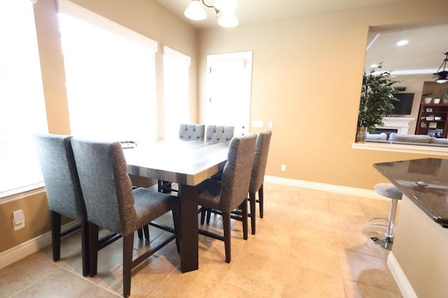 3309 Beverly Ave, Clovis, CA 93619 - dining area featuring a chandelier, baseboards, and light tile patterned flooring