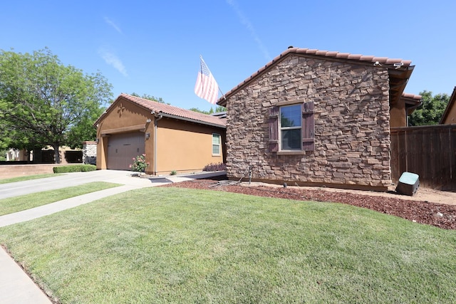 3309 Beverly Ave, Clovis, CA 93619 - ranch-style house with stone siding, a tile roof, a garage, concrete driveway, and stucco siding
