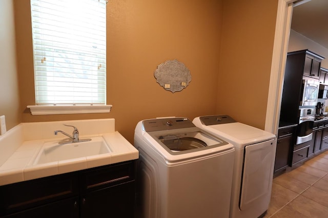 3309 Beverly Ave, Clovis, CA 93619 - laundry room with independent washer and dryer, cabinet space, and light tile patterned flooring
