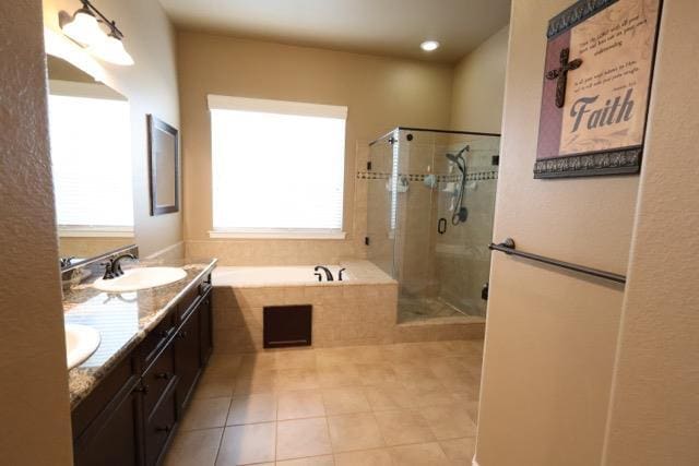 3309 Beverly Ave, Clovis, CA 93619 - bathroom featuring tile patterned flooring, double vanity, a garden tub, and a stall shower