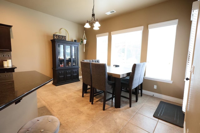 3309 Beverly Ave, Clovis, CA 93619 - dining room with baseboards, a chandelier, and light tile patterned floors