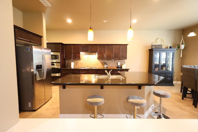 3309 Beverly Ave, Clovis, CA 93619 - kitchen with appliances with stainless steel finishes, a sink, a kitchen breakfast bar, and light tile patterned floors