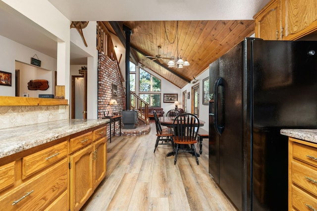 40758 Cold Springs Ln, Shaver Lake, CA 93664 - kitchen featuring black fridge with ice dispenser, light wood-style floors, wood ceiling, vaulted ceiling, and light stone countertops