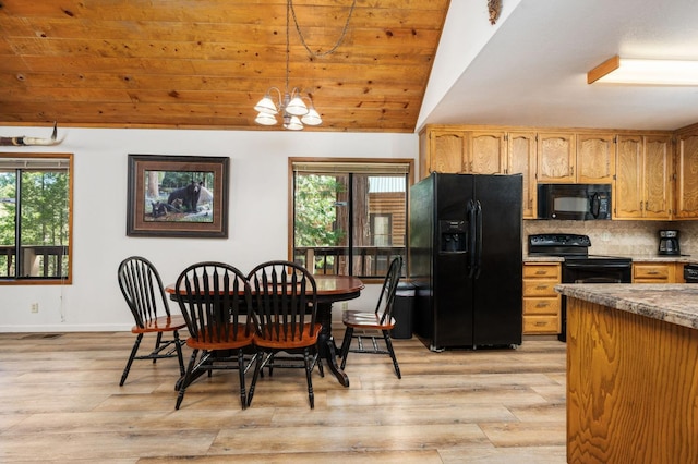 40758 Cold Springs Ln, Shaver Lake, CA 93664 - dining space featuring plenty of natural light, light wood-type flooring, a chandelier, vaulted ceiling, and baseboards