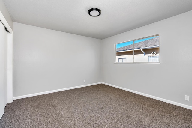708 E San Jose Ave, Fresno, CA 93710 - unfurnished bedroom with dark colored carpet, a closet, and baseboards