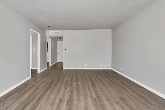 708 E San Jose Ave, Fresno, CA 93710 - empty room featuring wood finished floors, baseboards, and a textured ceiling