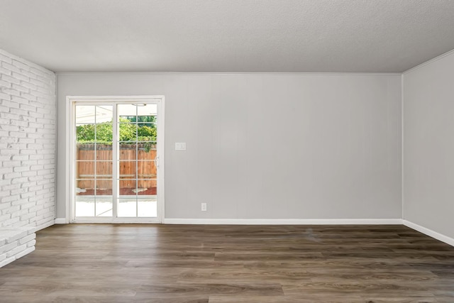 708 E San Jose Ave, Fresno, CA 93710 - spare room with wood finished floors, ornamental molding, baseboards, and brick wall