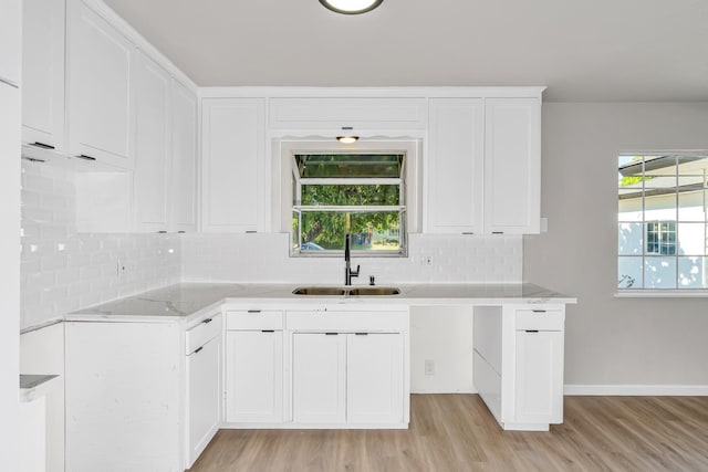 708 E San Jose Ave, Fresno, CA 93710 - kitchen with a sink, light wood finished floors, decorative backsplash, and white cabinetry