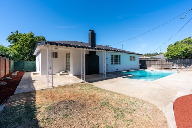 708 E San Jose Ave, Fresno, CA 93710 - rear view of house with a fenced backyard, a patio area, a chimney, and stucco siding