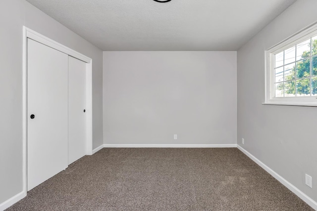 708 E San Jose Ave, Fresno, CA 93710 - unfurnished bedroom with carpet flooring, a closet, baseboards, and a textured ceiling