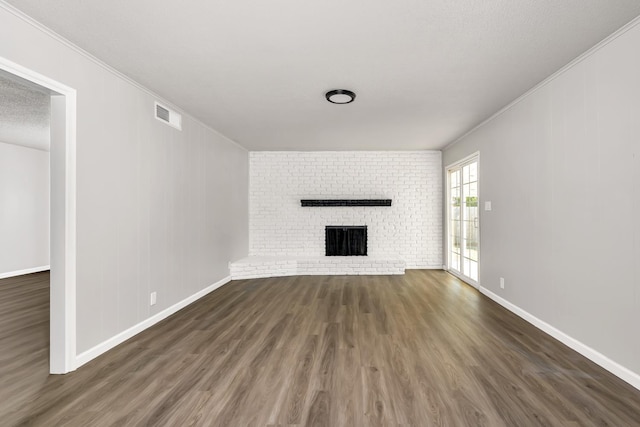 708 E San Jose Ave, Fresno, CA 93710 - unfurnished living room with wood finished floors, baseboards, crown molding, and a brick fireplace