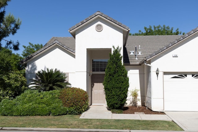 2300 Sierra Ave Unit 129, Kingsburg, CA 93631 - single story home with a garage, stucco siding, and a tiled roof