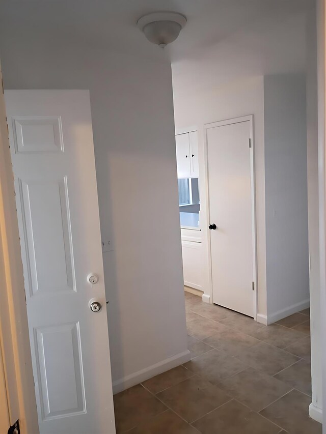 3332 W Shields Ave Unit 101, Fresno, CA 93722 - hallway with baseboards and tile patterned flooring