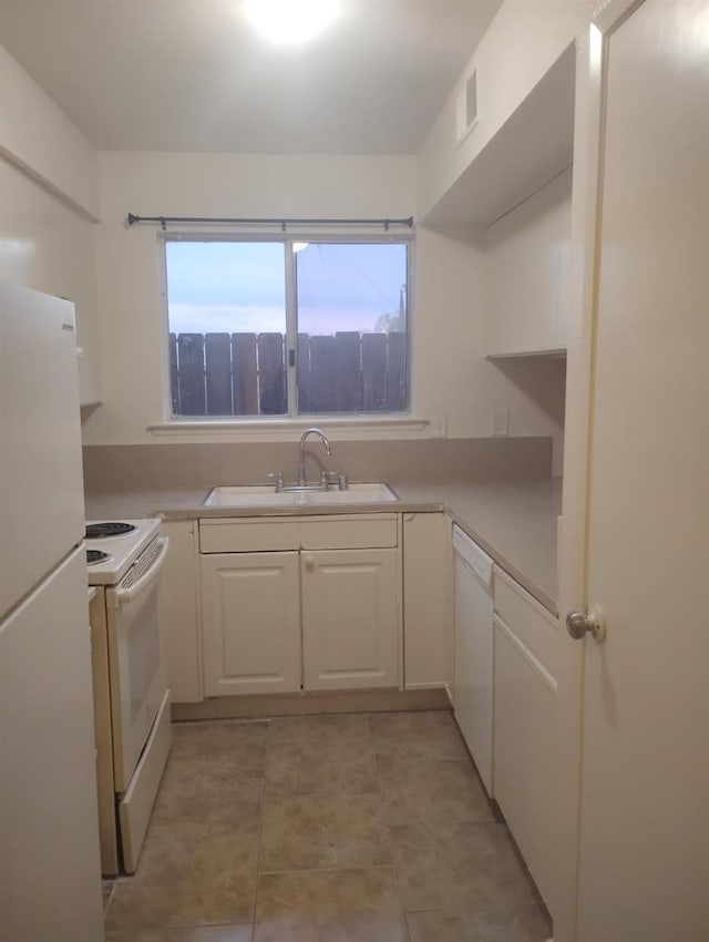3332 W Shields Ave Unit 101, Fresno, CA 93722 - kitchen with white appliances, a sink, white cabinetry, light tile patterned floors, and light countertops