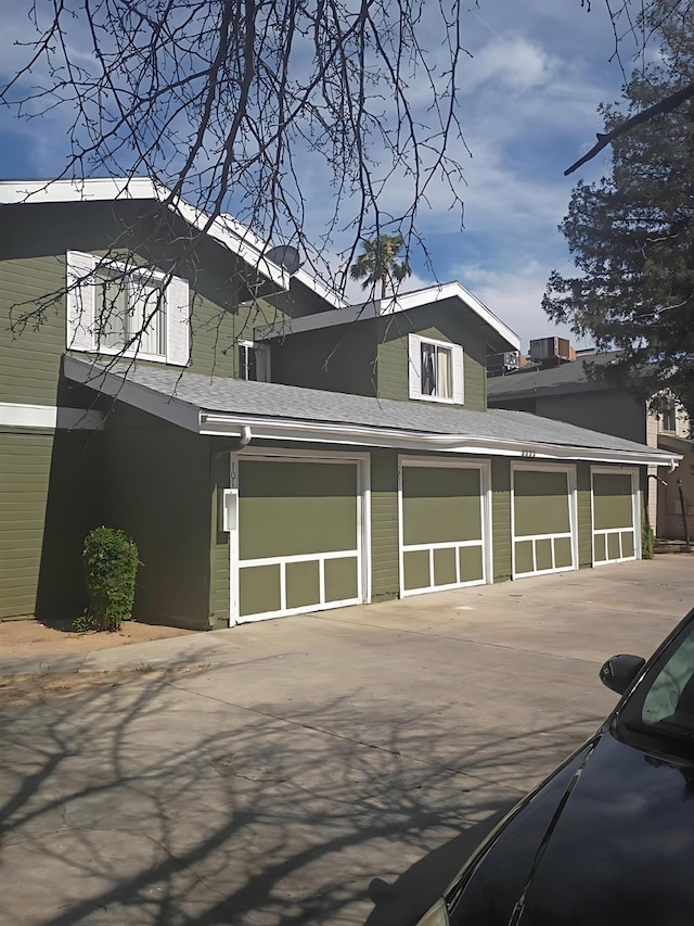 3332 W Shields Ave Unit 101, Fresno, CA 93722 - view of side of property with a shingled roof and driveway