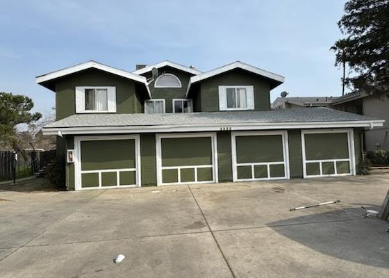 3332 W Shields Ave Unit 101, Fresno, CA 93722 - view of front of house with a garage, driveway, and a shingled roof