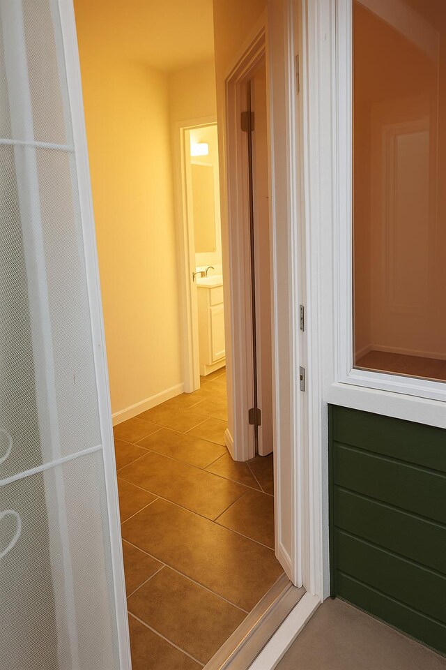 3332 W Shields Ave Unit 101, Fresno, CA 93722 - hall with tile patterned floors, a sink, and baseboards