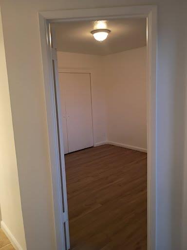 3332 W Shields Ave Unit 101, Fresno, CA 93722 - corridor with baseboards and wood finished floors