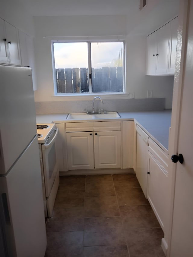 3332 W Shields Ave Unit 101, Fresno, CA 93722 - kitchen featuring white appliances, a sink, white cabinets, and light countertops