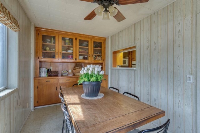 44468 Lakeview Ave, Shaver Lake, CA 93664 - dining area featuring wooden walls, a ceiling fan, and light floors