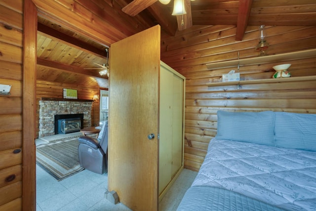 44468 Lakeview Ave, Shaver Lake, CA 93664 - bedroom with log walls, wood ceiling, a stone fireplace, and tile patterned floors