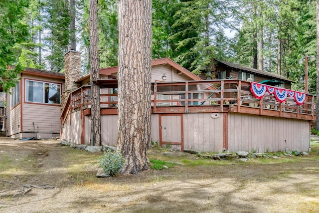 44468 Lakeview Ave, Shaver Lake, CA 93664 - view of property exterior with a chimney and a wooden deck