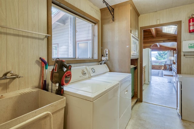 44468 Lakeview Ave, Shaver Lake, CA 93664 - washroom with separate washer and dryer and wood walls