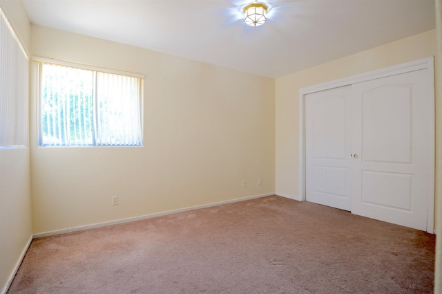 621 E Keats Ave, Fresno, CA 93710 - unfurnished bedroom featuring light carpet, a closet, and baseboards