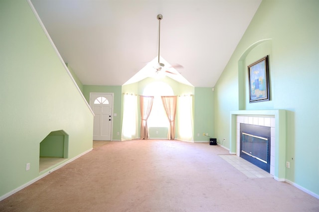 621 E Keats Ave, Fresno, CA 93710 - unfurnished living room featuring carpet flooring, a tile fireplace, ceiling fan, lofted ceiling, and baseboards