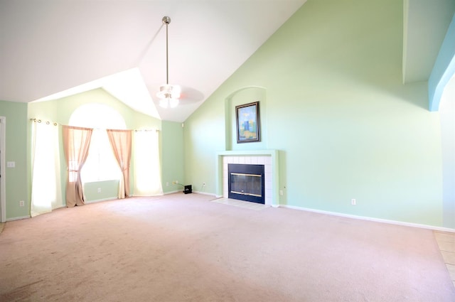 621 E Keats Ave, Fresno, CA 93710 - unfurnished living room featuring light carpet, a tiled fireplace, baseboards, high vaulted ceiling, and a ceiling fan