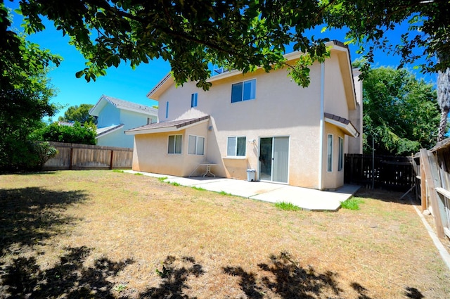 621 E Keats Ave, Fresno, CA 93710 - rear view of property with stucco siding and a patio