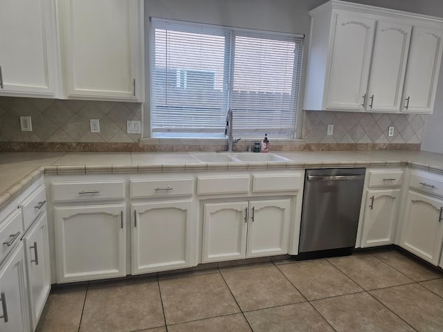 3351 Winter Way, Madera, CA 93637 - kitchen featuring stainless steel dishwasher, a sink, light tile patterned flooring, white cabinets, and healthy amount of natural light