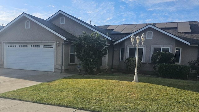 3351 Winter Way, Madera, CA 93637 - ranch-style home featuring driveway, a garage, a front yard, stucco siding, and roof mounted solar panels