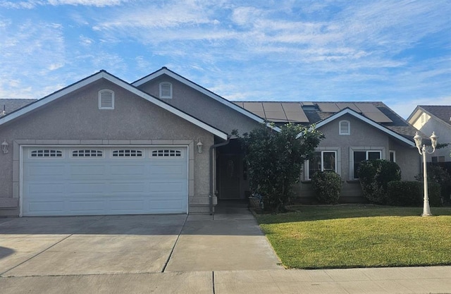 3351 Winter Way, Madera, CA 93637 - ranch-style house with a front lawn, concrete driveway, an attached garage, roof mounted solar panels, and stucco siding