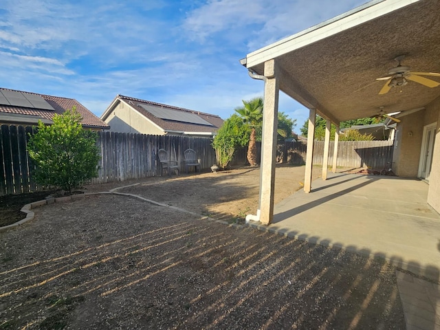 3351 Winter Way, Madera, CA 93637 - fenced backyard with ceiling fan and a patio