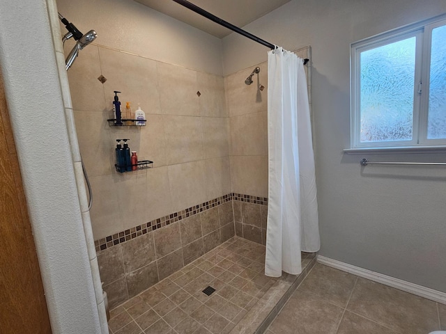 3351 Winter Way, Madera, CA 93637 - bathroom with a tile shower, tile patterned floors, and baseboards