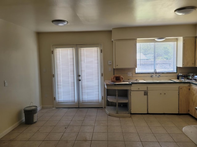 3023 E Robinson Ave, Fresno, CA 93726 - kitchen featuring french doors, white cabinets, light tile patterned floors, and baseboards