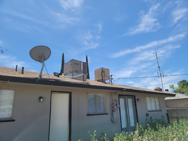 3023 E Robinson Ave, Fresno, CA 93726 - rear view of property with central AC, stucco siding, and french doors