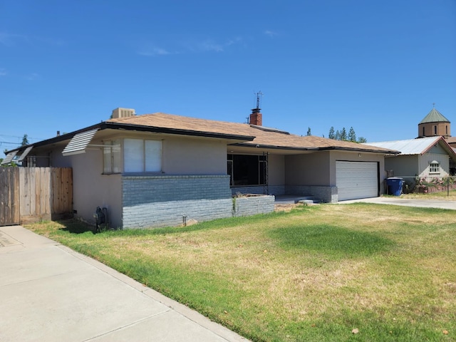 3023 E Robinson Ave, Fresno, CA 93726 - ranch-style house with brick siding, a garage, driveway, and stucco siding