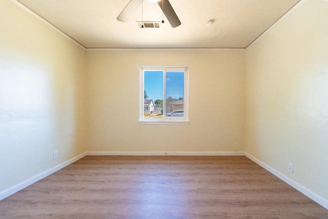 2744 E Michigan Ave, Fresno, CA 93703 - empty room featuring ceiling fan, wood finished floors, baseboards, and crown molding
