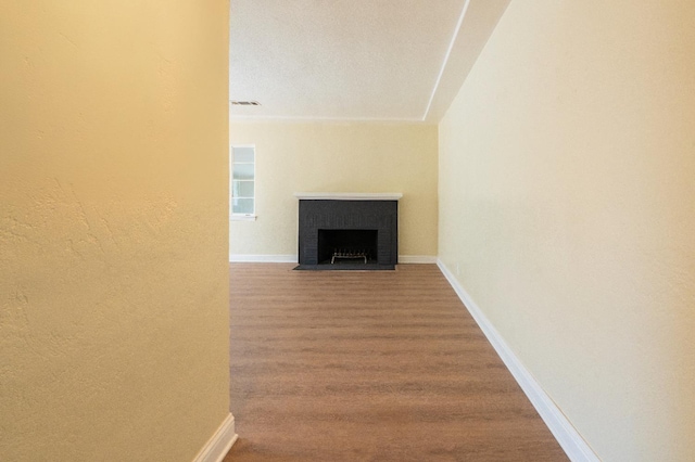2744 E Michigan Ave, Fresno, CA 93703 - unfurnished living room with wood finished floors, baseboards, and a fireplace with flush hearth